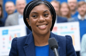 Conservative Party Challenges: Kemi Badenoch’s Leadership Tested in Local Elections Alt Text: Kemi Badenoch speaking at the Conservative Party’s 2025 local election campaign launch in Buckinghamshire, with supporters and charts in the background.