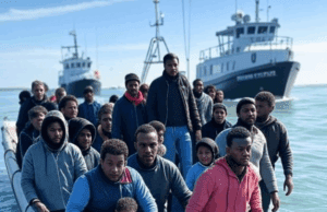 Immigration and Border Security Challenges Under Labour Government in 2025 Alt Text: Small boat migrants crossing the English Channel, with Border Force vessels in the background, highlighting immigration and border security challenges in 2025.