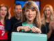 Taylor Swift New Album Buzz: Unveiling ‘The Life of a Showgirl’ Alt Text: Taylor Swift unveiling The Life of a Showgirl on the New Heights podcast with Travis and Jason Kelce, holding a mint green briefcase.