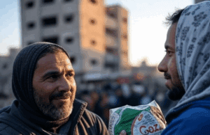 UK Boosts Aid to Gaza Amid Israel-Hamas Conflict Escalation Alt Text: Humanitarian aid workers distributing supplies in Gaza during Israel-Hamas conflict.